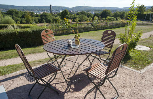 © view - die agentur Blick vom Kaiserberg auf die Stadt. Im Vordergrund sieht man einen Holztisch mit vier Stühlen. © view - die agentur
